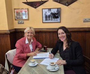 Diane Dodd and Jessica Ferey sign the partnership agreement